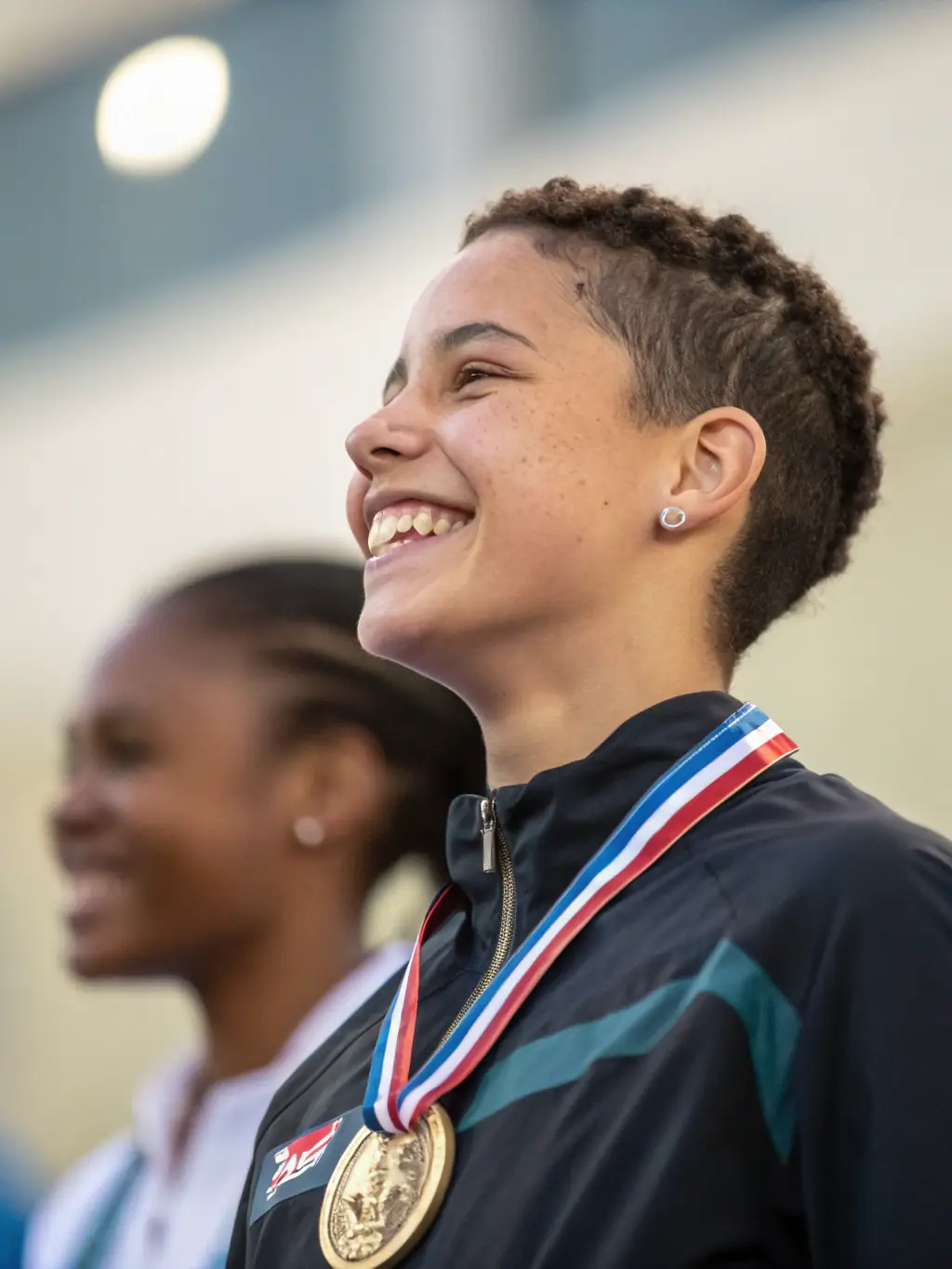 An inspiring image of young athletes receiving medals at a local sports event, showcasing achievement and community support.